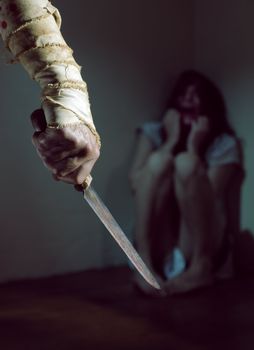 Scared woman threatened by a man with bloody knife