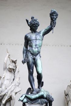 Famous bronze statue of Perseus holding head of Medusa by Benvenuto Cellini is standing on Loggia dei Lanzi, Florence, Italy. 