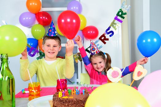 Happy little children are having fun in a birthday party 