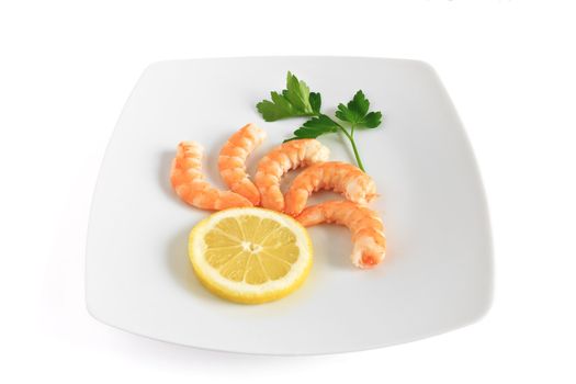 five shelled shrimps with lemon and parsley on a plate isolated on white background with clipping path