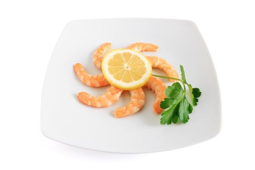 shelled shrimps with lemon and parsley on a plate isolated on white background with clipping path