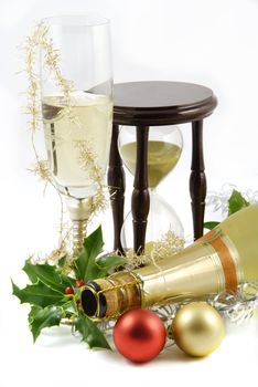 Happy new year background with glass of champagne and hourglass