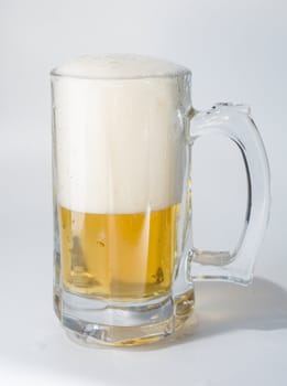 Mug, full of cold lager beer. Isolated.