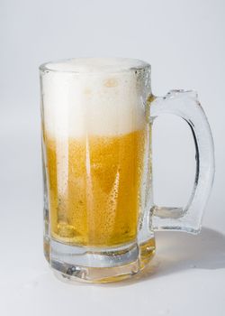 Mug, full of cold lager beer. Isolated.