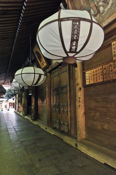 Row of beautiful lanterns hanging from the roof of a Japanese temple