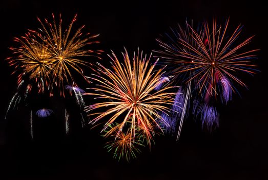 Beautiful colorful holiday fireworks on the night sky background, long exposure