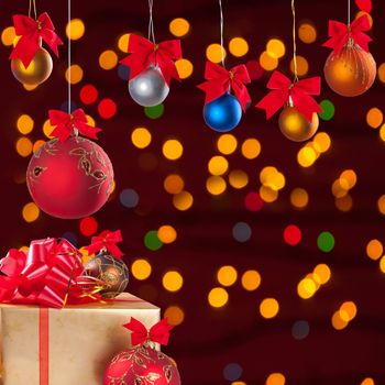 Christmas balls on ribbon and gifts on festive background