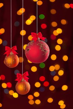 Christmas balls on ribbon on festive background