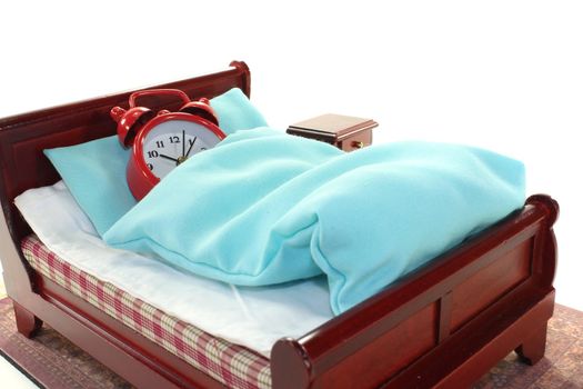 Sleepy - alarm clock in bed with bedside and blue bedding
