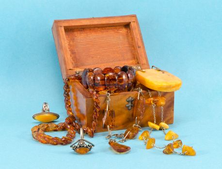 Amber apparel jewelry in retro wooden box on blue background