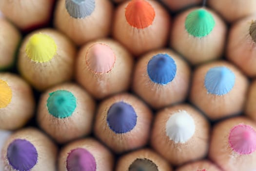 An extreme macro view of colour pencils arranged in a row