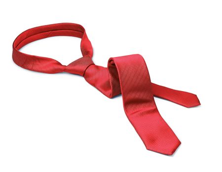 Red men's tie taken off for leisure time, white background isolated