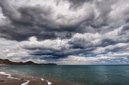 View of thunderstorm clouds above the sea