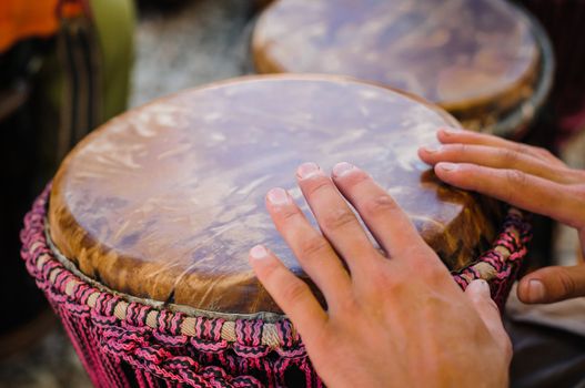 Man playing the djembe (african drum) outdoors