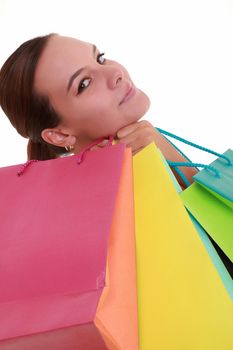 Young woman with colorful shopping bags isolated