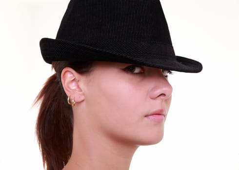 Serious beautiful young woman with black hat