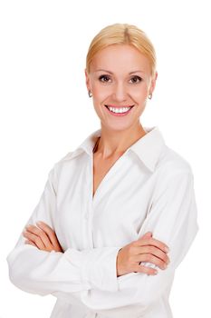 Beautiful young businesswoman standing with hands folded against white background