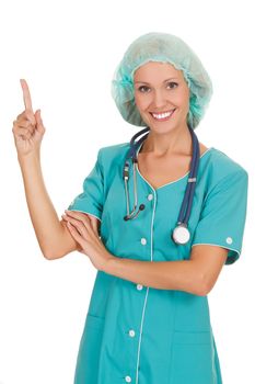 happy young doctor pointing at something interesting against white background