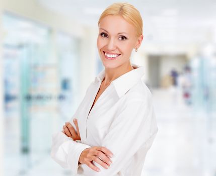 young business woman in the office smiling to you