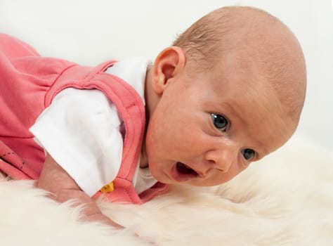 baby on white sheep's clothing.