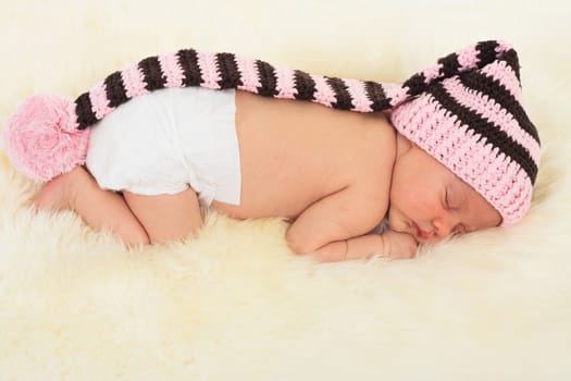 infant sleeping in the white sheep's clothing.