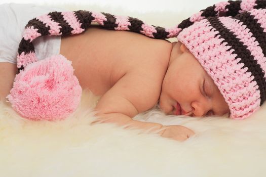 infant sleeping in the white sheep's clothing.