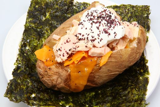Abacore Tuna stuffed Baked Potato on Seaweed with Dulse Flakes, Cheese and Sour Cream