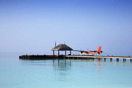 Sea plane docked at the arrival pier of a holiday resort in the Maldives