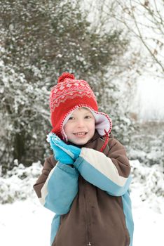 Portrait of a happy boy outdoors in the snow.