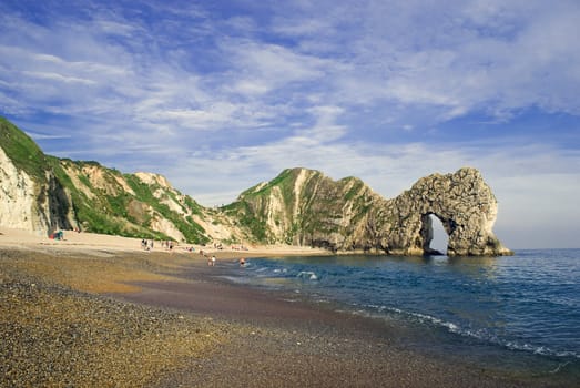 Durdle Door in Dorset UK, a natural arch caused by limestone erosion.