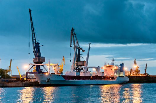 Shipyard with ship at dusk time with beautiful cloudscape