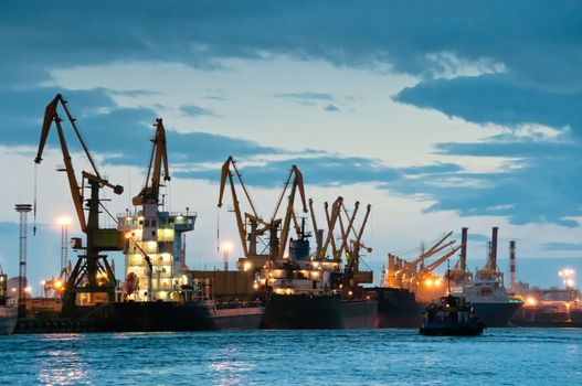 Shipyard with ships at dusk time with beautiful cloudscape