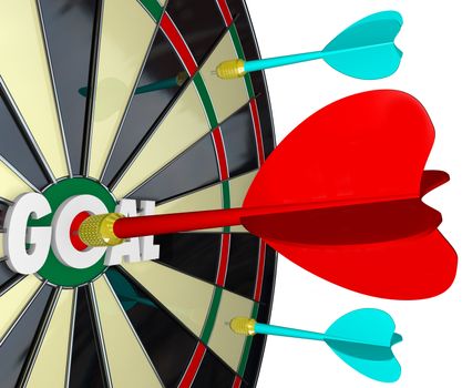 The word Goal on a dartboard and one dart hits right into the center of it into the bulls-eye to achieve a mission or complete an objective, such as winning a game or competition