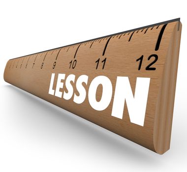 A wooden ruler with the word Lesson to represent teaching and education in communicating an important message