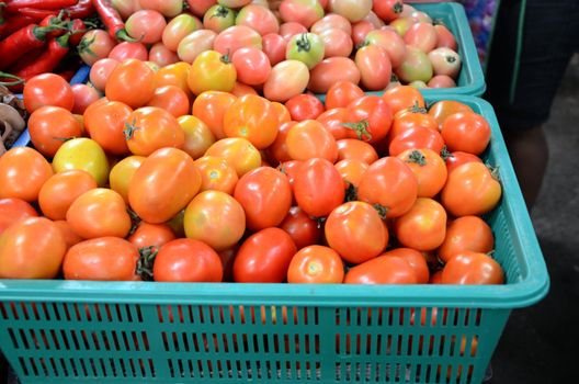 Baskets of tomatoes for sale at a farmer's market. 