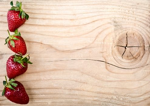 Fresh strawberries on old wooden background