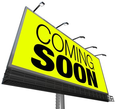 The words Coming Soon on a large outdoor billboard on a yellow background advertises a new store, grand opening, sneak preview of a movie or feature or other event, product or object