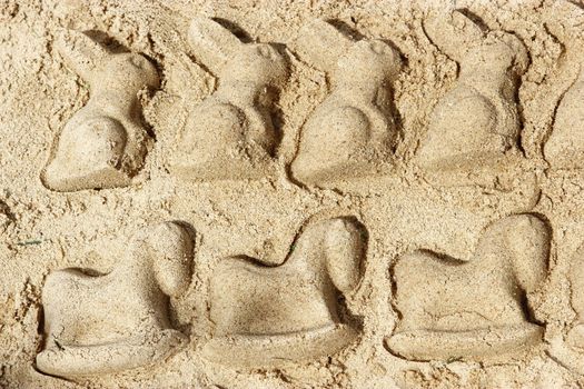 hose and rabbit of sand made by child