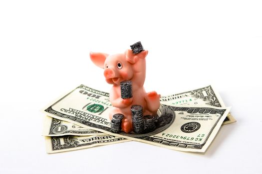 artificial piggy with coins and money on the white background