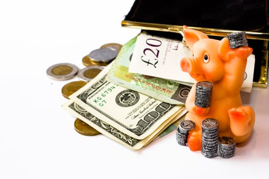 artificial piggy with coins and money on the white background