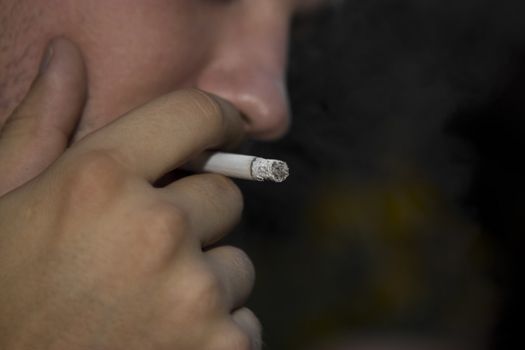 Yang man smoking a cigarette