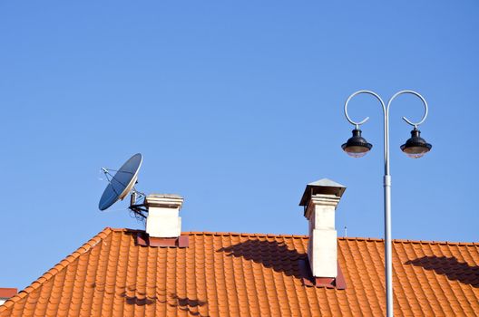 old city tiles roof with chimney and lamp