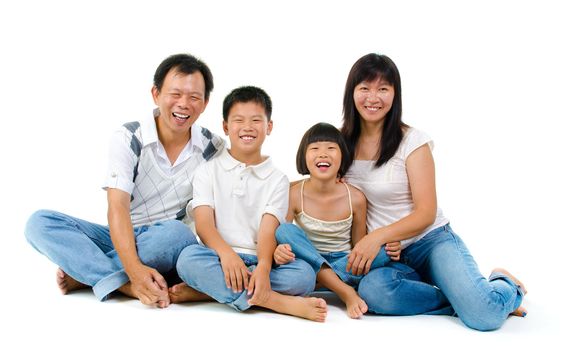 Fullbody happy Asian family sitting on white background