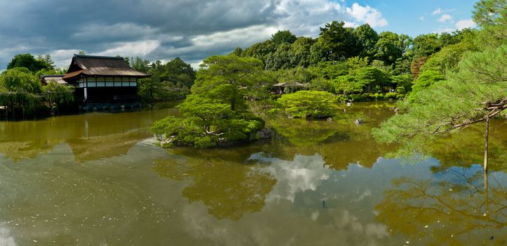 Beautiful Japanese Garden near Heian Shrine is reflecting in the calm water.