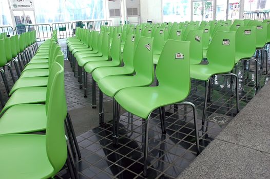 Green chairs rows in conference hall