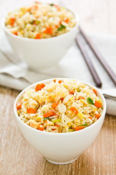 Fried rice with crab ,carrot,spring onion shrimp and egg in white bowls