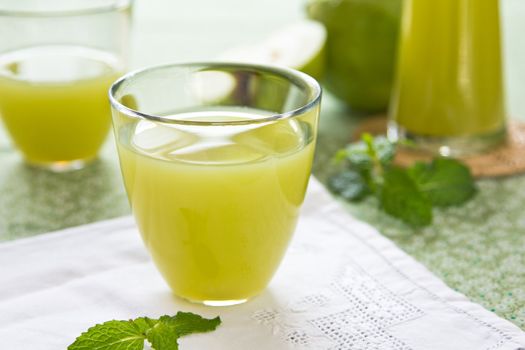 Guava juice with mint  in glasses and jug by fresh guava
