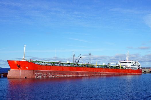 The tanker is moored in the port and loaded fuel