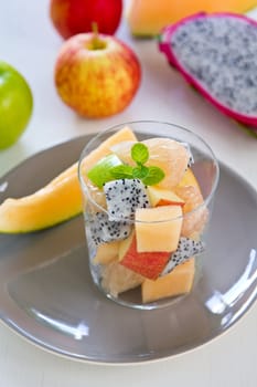 Fruit salad in glass [ apple,cantaloupe,dragon fruit ]