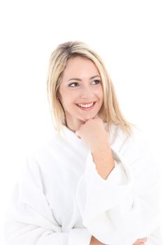 Beautiful woman smiling happily as she cuddles in a soft white fresh towelling bathrobe Beautiful woman smiling happily as she cuddles in a soft white fresh towelling bathrobe